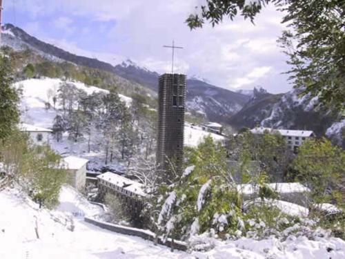 a snow covered mountain with a building in the distance at Goiko-Benta Ostatua in Oñate