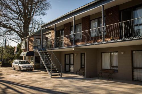 a building with a staircase on the side of it at Aotea Motel in Christchurch