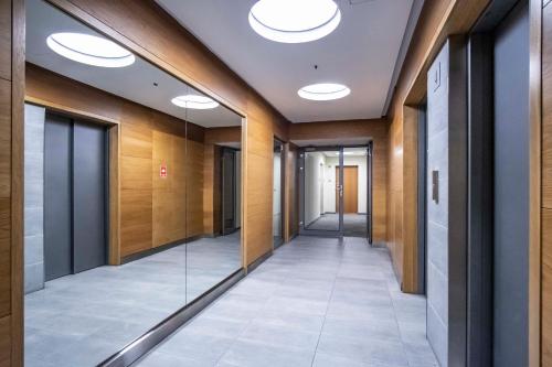 a hallway of an office building with lights on the ceiling at Dworzec Gdański Apartament in Warsaw