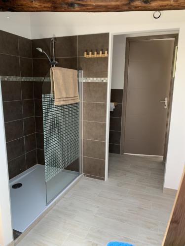 une salle de bain avec une douche avec une porte vitrée dans l'établissement L'Atypique, à Sète