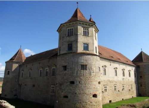 an old building with a tower on top of it at Pensiunea Oficial in Prejmer