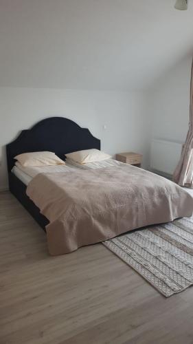 a bed in a bedroom with a rug on the floor at Casa Davideea in Colibiţa