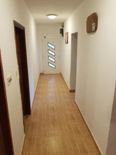 a hallway with white walls and a wooden floor at Apartment Marina in Senj