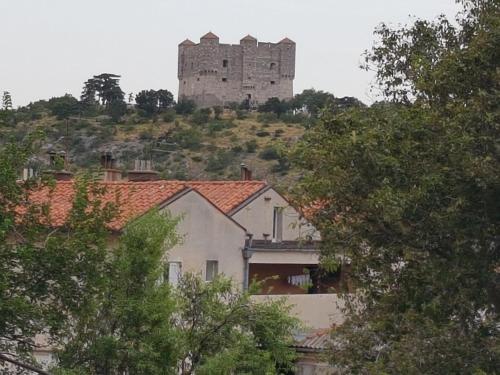a castle on top of a hill with houses at Apartment Marina in Senj