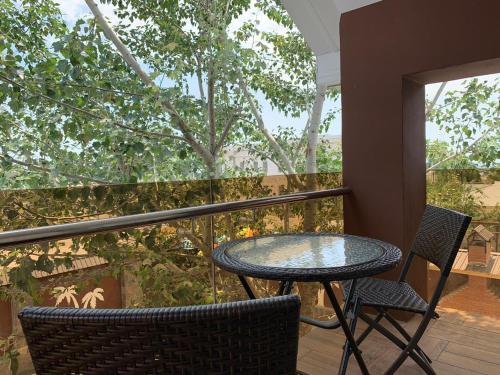 a patio table and chairs on a balcony with a view at Qafqaz Fountain Villa in Gabala
