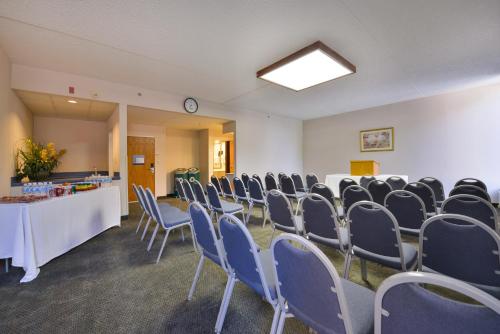 a room with rows of chairs and a table in it at Greenstay Hotel & Suites Central in Springfield