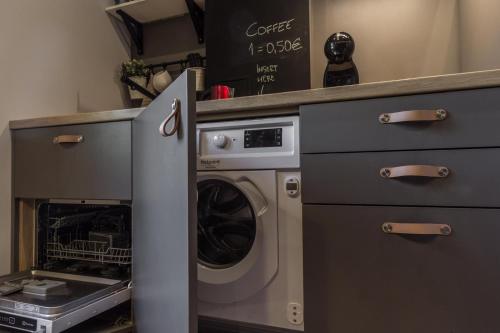 a kitchen with a dishwasher and a washer and dryer at S7 Apartment in Rīga