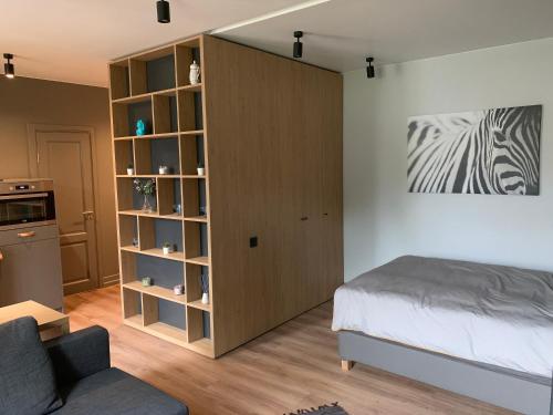 a bedroom with a bed and a book shelf at S7 Apartment in Rīga