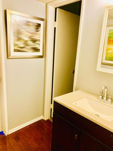 a bathroom with a sink and a mirror at Desert Getaway in Desert Hot Springs