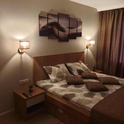 a bedroom with a bed with two pillows on it at Apartamenti Danna in Lēdmane