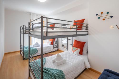 a room with two bunk beds and a bed at OCEANFRONT: Luxury Magnificent Views and Pool in Olhão