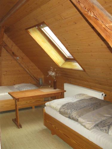 a attic bedroom with two beds and a skylight at Pension Köthen in Köthen