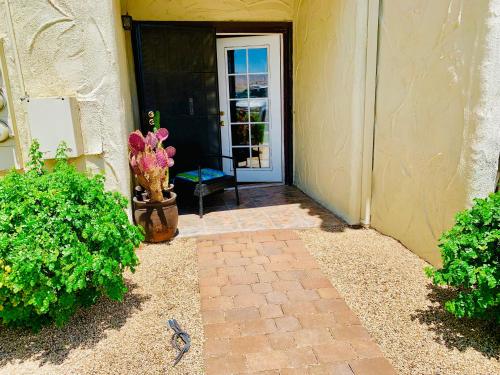 a front door of a house with a vase of flowers at Desert Getaway in Desert Hot Springs