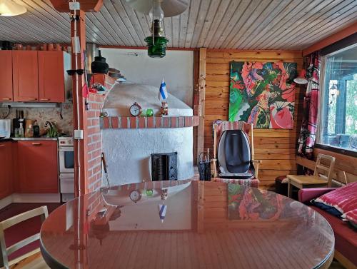 a kitchen with a glass table in a room at Pistoretki Toivakka in Toivakka