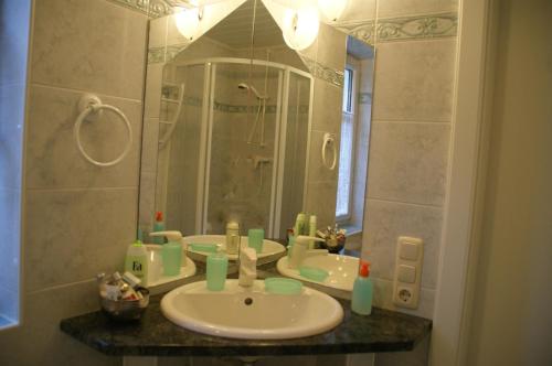 a bathroom with a sink and a mirror at Landhaus Herzog in Maria Alm am Steinernen Meer