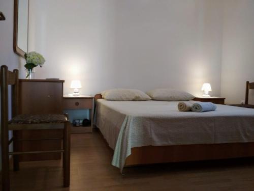 a bedroom with a bed and two tables and two lamps at Antun Mozara Family House in Slano