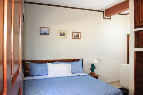 a bedroom with a blue bed with blue pillows at Zona Romántica Casa Las Magnolias in Puerto Vallarta