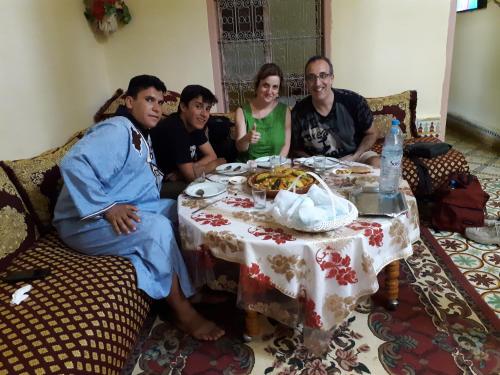 a group of people sitting around a table at Écologie oasis tafilalt CHEZ L' HABITANT in Er Rachidia