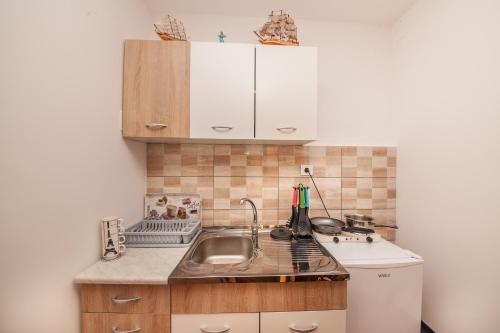 a small kitchen with a sink and a counter at Alex Guesthouse in Kotor
