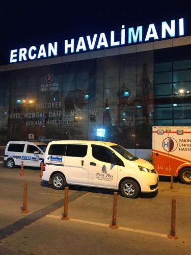 a white van parked in front of a building at Karia Plus City Apartments in Kérynia