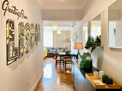 a living room with a couch and a table at Home Out Central Roma Apartment in Lisbon