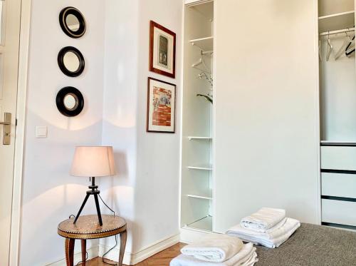 a room with a closet with a lamp and towels at Home Out Central Roma Apartment in Lisbon