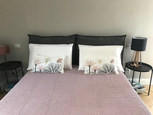 a bed with two pillows on it with two tables at ML32 in Ravenna