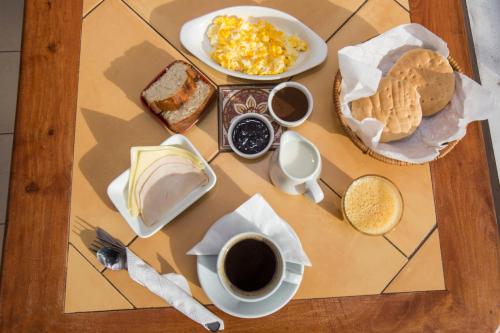a table with breakfast foods and a cup of coffee at Hotel Amalfi - ex Santisimo in Viña del Mar