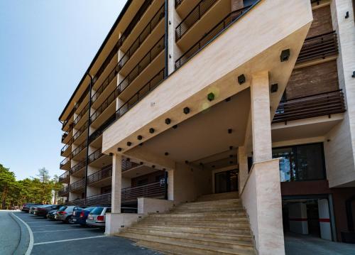 a building with stairs on the side of it at LUX apartman u vili Pekovic in Zlatibor
