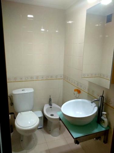 a bathroom with a tub and a toilet and a sink at Lila Ocean View Apartment in Ponta Delgada