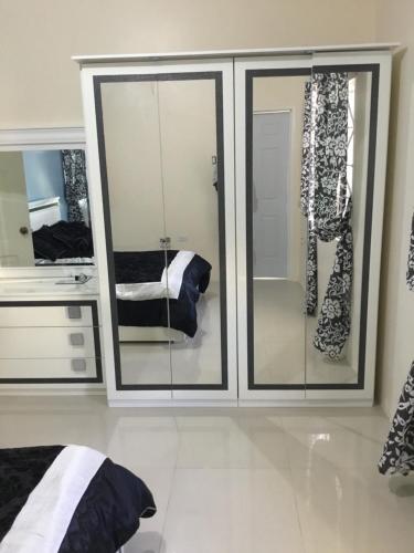 a room with glass doors and a bathroom with a sink at Cool Breeze Discovery Bay in Discovery Bay