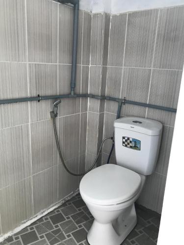 a bathroom with a white toilet in a stall at Tám Thọ homestay in Tân Hiệp