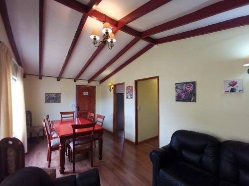a living room with a table and a dining room at Casas Isla Negra in El Quisco