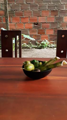 a bowl of fruit sitting on a table at Posada El Acuario in Bahía Solano