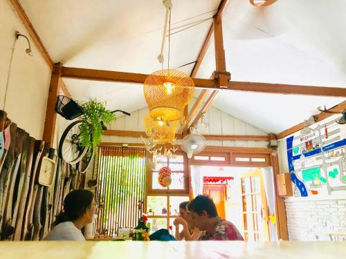 een groep mensen die aan een bar zitten bij Pailin Guest House in Bangkok