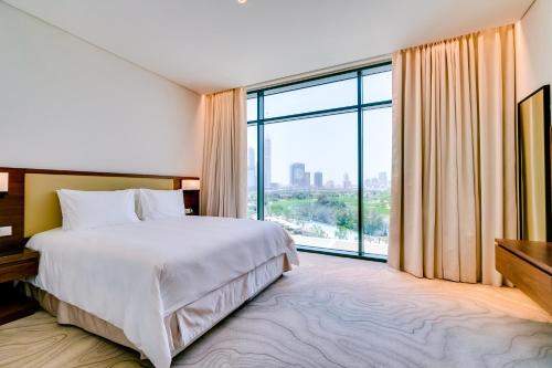 Vuode tai vuoteita majoituspaikassa Vida Emirates Hills Residences