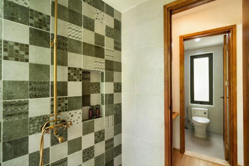 a bathroom with a shower and a toilet at Mimi House in Hoi An