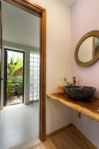 a bathroom with a sink and a mirror at Mimi House in Hoi An