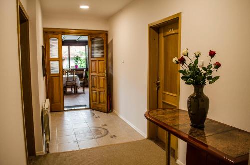 a hallway with a vase of flowers on a table at Demi Old Town - Garage Parking in Sarajevo