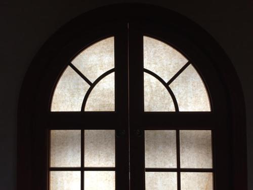 an arched window in a dark room at BluePlanet in Gyeongju