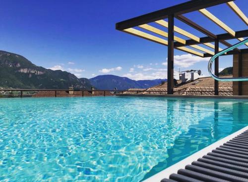 a pool of water with mountains in the background at Apparthotel Gartenresidence Nalserhof in Nalles
