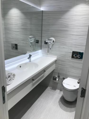 a bathroom with a white tub and a toilet at Oyster Boutique Hotel in Side