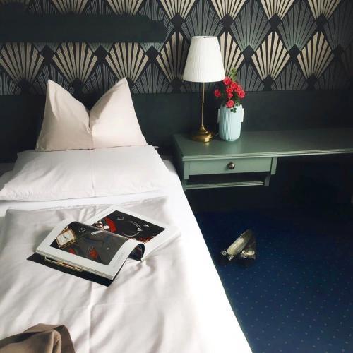 a bedroom with a bed with a book on it at VILLA OXA - Boutique Design Hotel in Maria Alm am Steinernen Meer