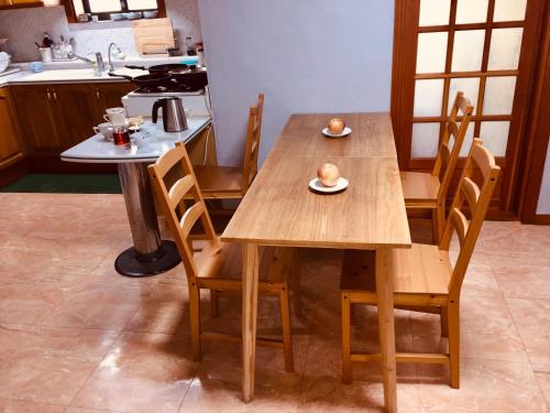 a kitchen with two tables with chairs and a sink at BluePlanet in Gyeongju