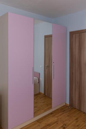 an empty room with white walls and wooden doors at Hiora Apartments Vasiliko in Tsarevo