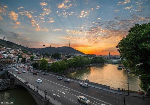 a city with a bridge and a river with cars at King Gorgasali in Tbilisi City