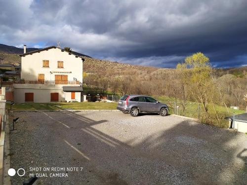 a car parked in a parking lot in front of a house at Apartamento Angostrina in Angoustrine