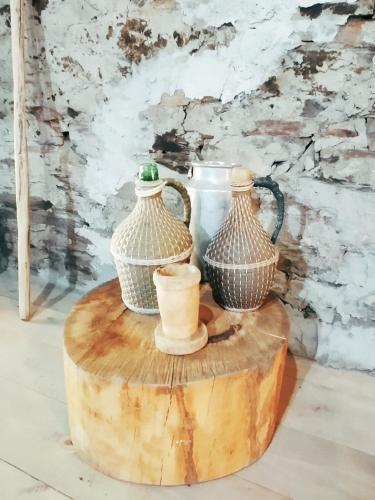 a group of vases sitting on top of a wooden table at Raul Lushnu Darbaz in Mestia
