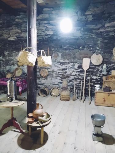 a room with baskets on the ceiling of a building at Raul Lushnu Darbaz in Mestia