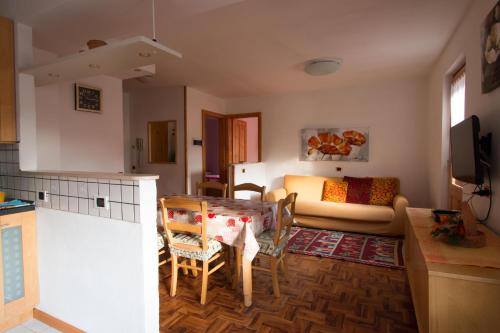 eine Küche und ein Wohnzimmer mit einem Tisch und Stühlen in der Unterkunft Baita Blesaccia in Livigno